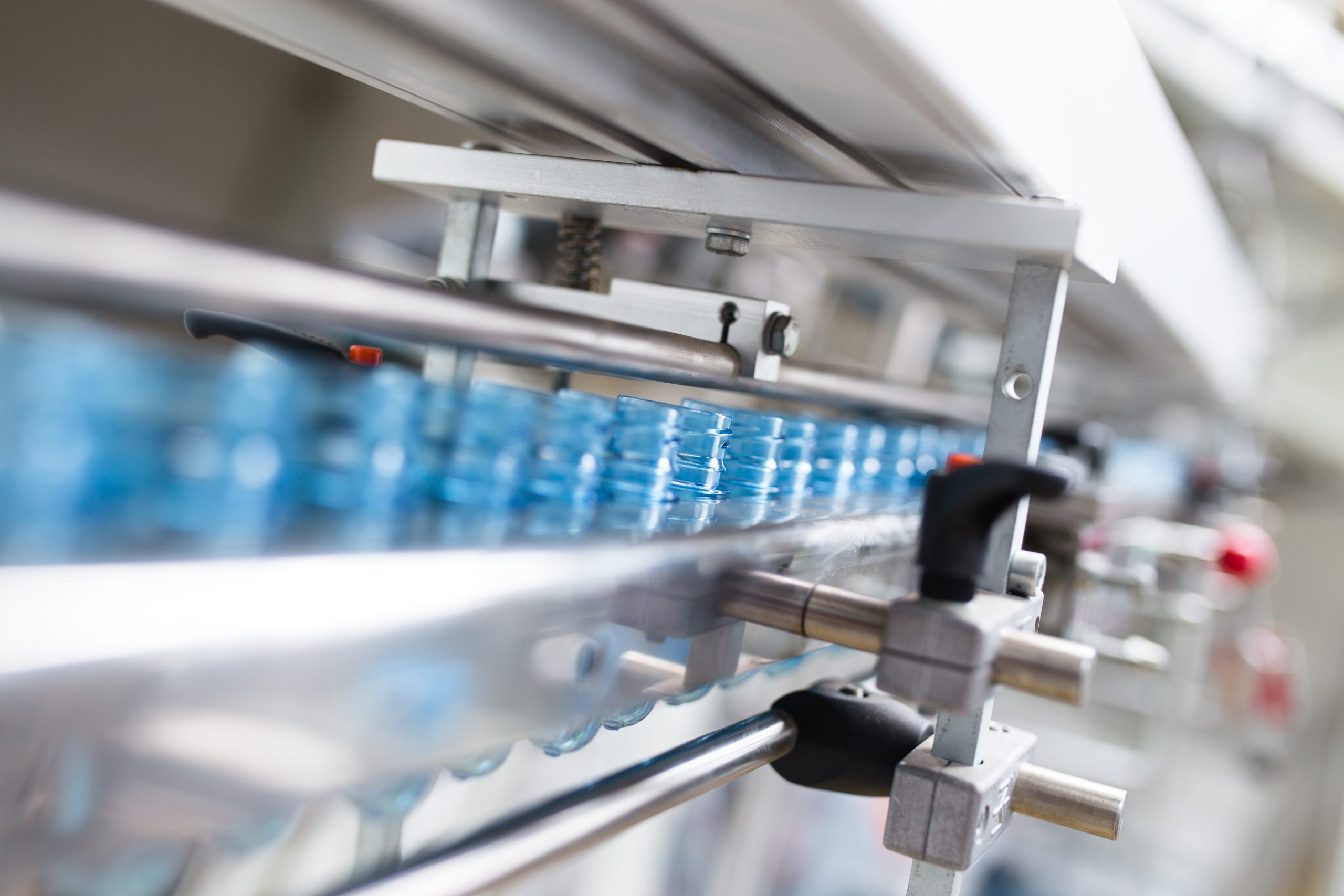 PET Preform. Automated blow molding machine for PET blowing in plastic bottles. Robotic line. Industrial technology.
